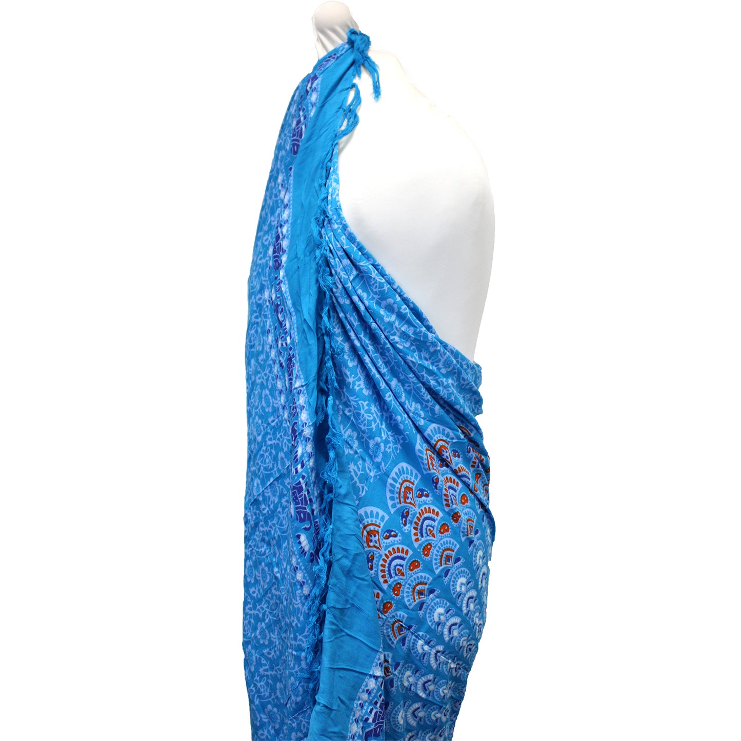 Side view of blue mandala sarong with red and navy peacock fan print and draped fringe