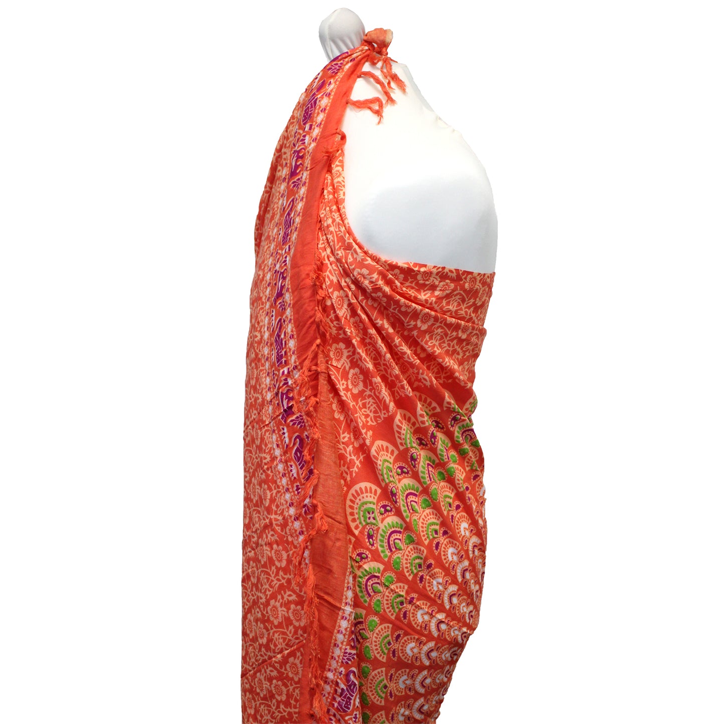 Side view of orange mandala sarong showing intricate green, purple, and red pattern with fringe edges