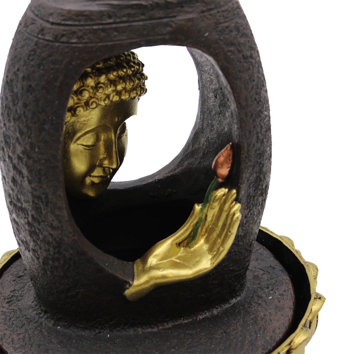 Close-up view of golden Buddha face and Vitarka Mudra hand with lotus in indoor fountain
