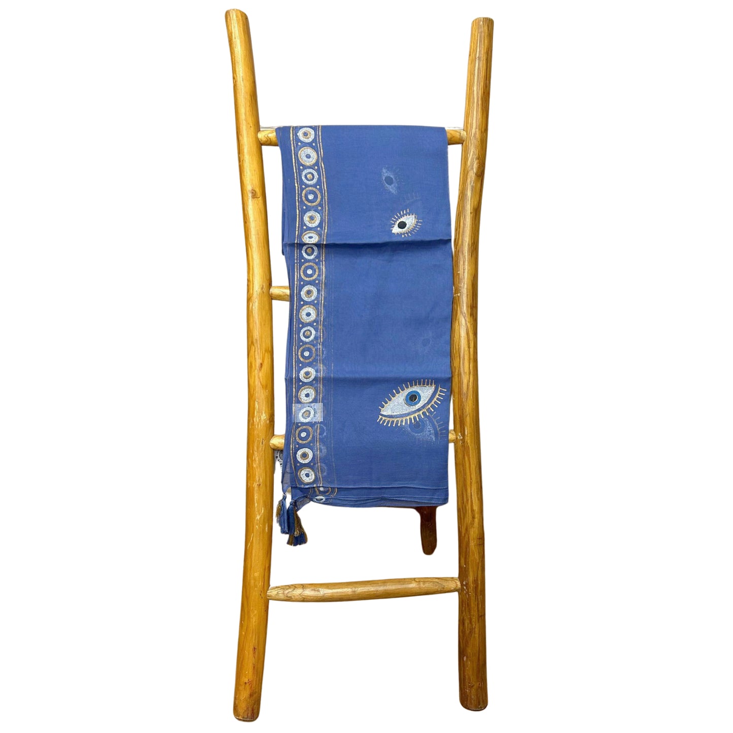 Blue cotton pario with hand-painted evil eyes and border pattern, shown folded on wooden display ladder