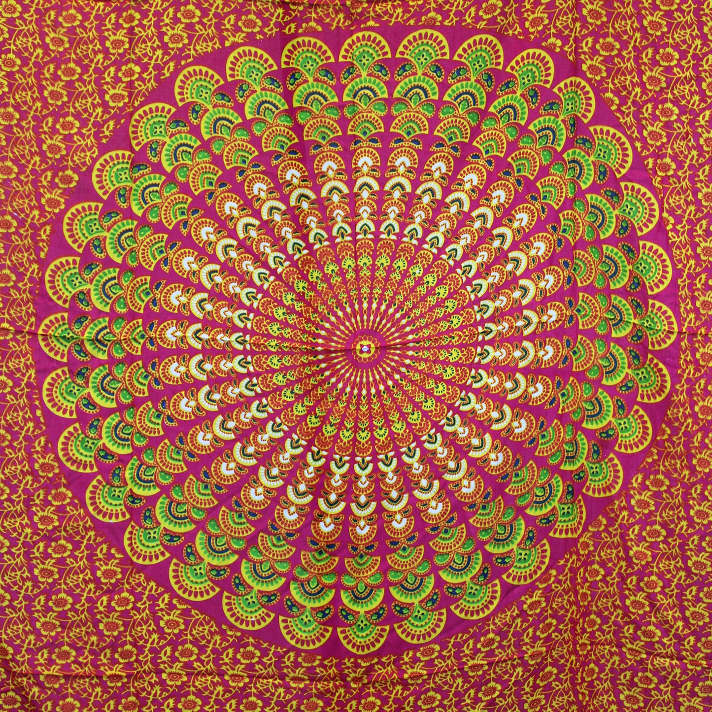 Laid flat fuchsia sarong featuring large circular mandala in lime, yellow, and green tones