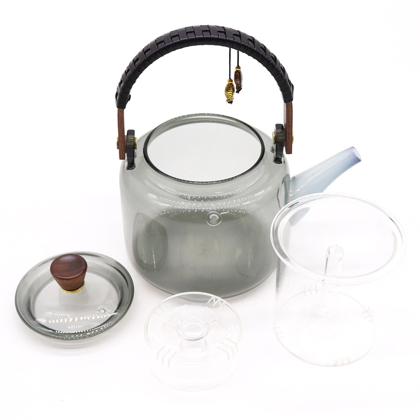 Disassembled glass teapot with transparent steamer insert and matching lid