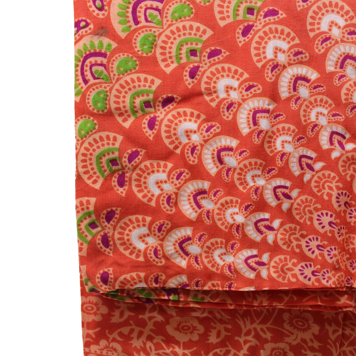 Detailed close-up of orange sarong fabric with pink, green, and purple mandala fan motifs