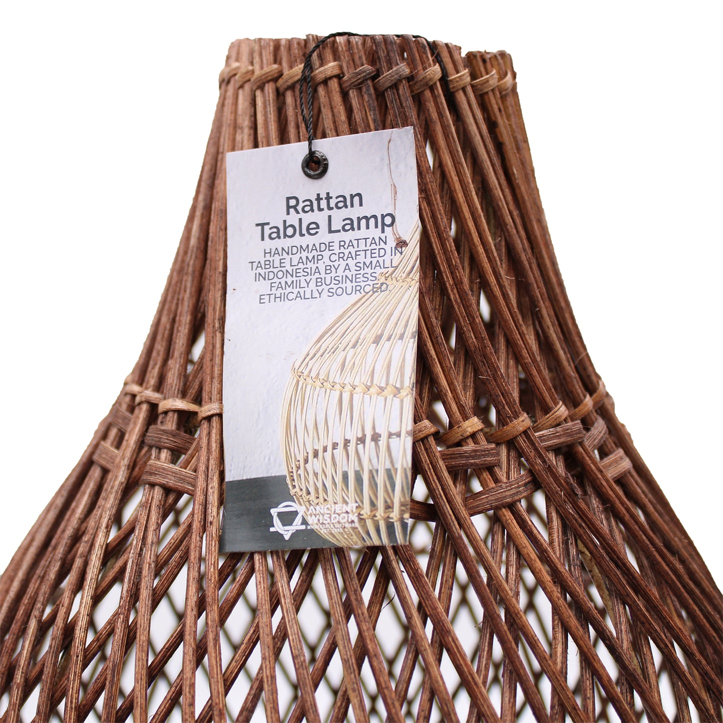 Close-up of product tag attached to the rattan lamp, showcasing handmade origin and branding.