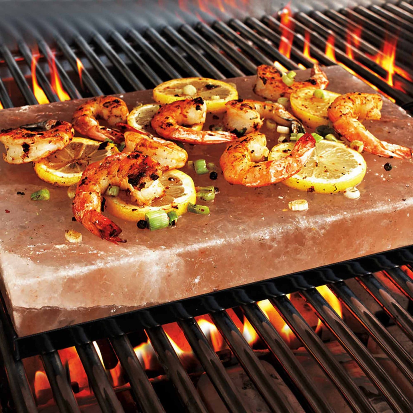 Vegetables grilling on Himalayan salt slab over BBQ flames
