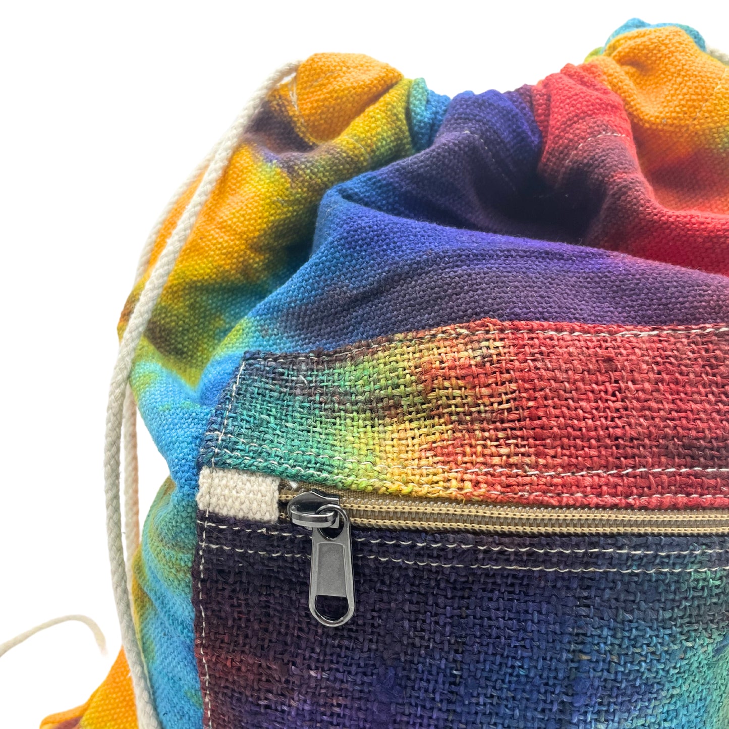 Close-up of zipper and vibrant hemp fabric on tie-dye drawstring bag, showing texture and artisan dye pattern
