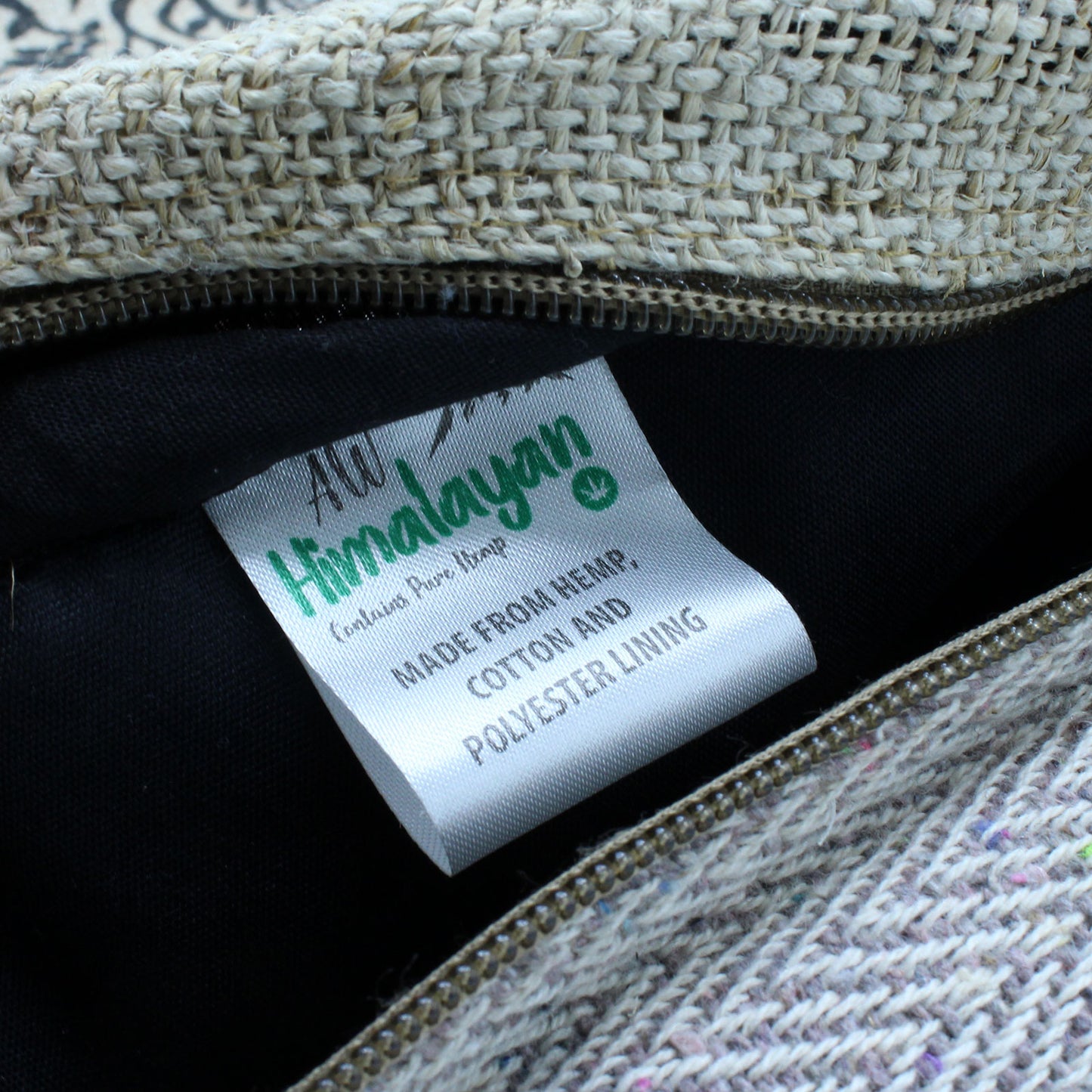 Close-up of inner label on hemp backpack showing hemp, cotton, and polyester lining construction for durability and structure