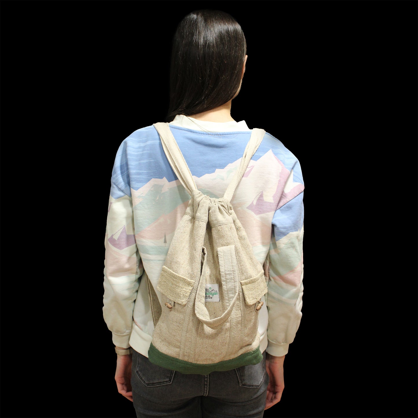 Studio view of model wearing large eco hemp backpack, showing ergonomic fit and natural fibre design for everyday use