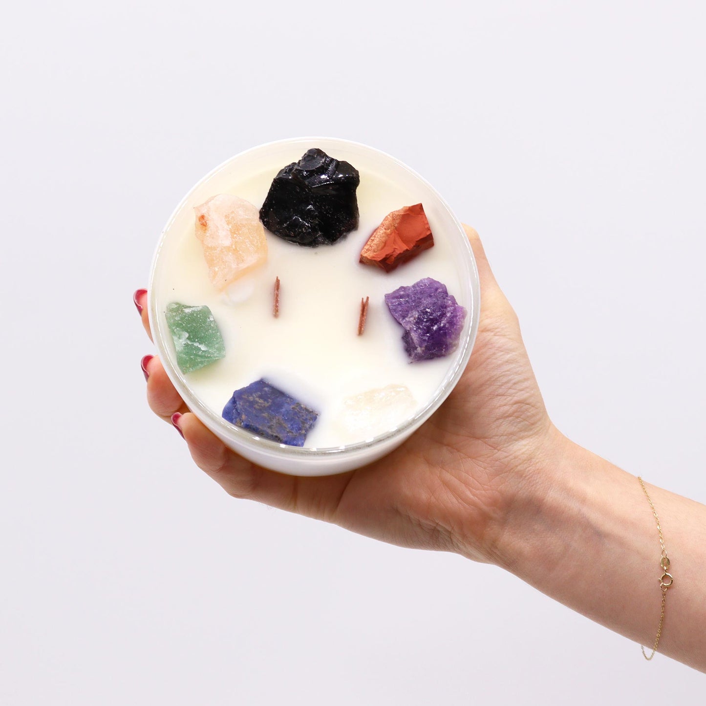 Seven Chakra Candle styled in a spiritual setting for rituals, reiki, and holistic chakra alignment practices