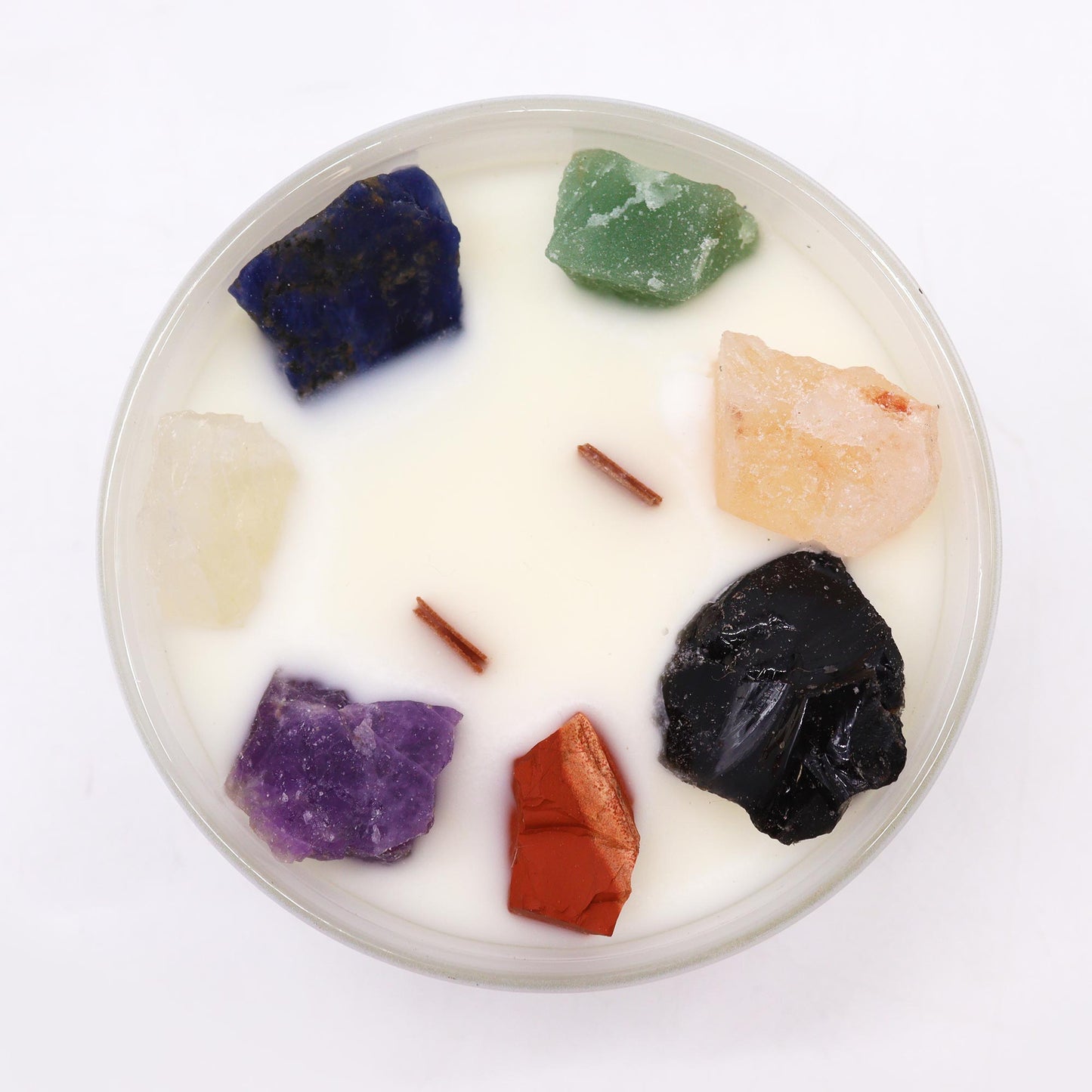 Top view of Seven Chakra Candle showing embedded gemstones and layered soy wax colors