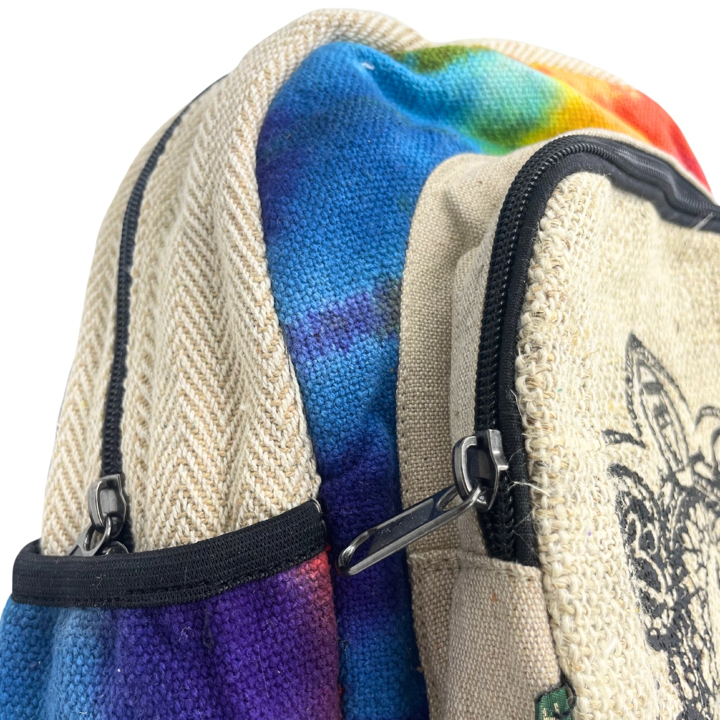 Close-up of zippers and stitching on colorful tie-dye chakra hemp backpack with natural herringbone weave