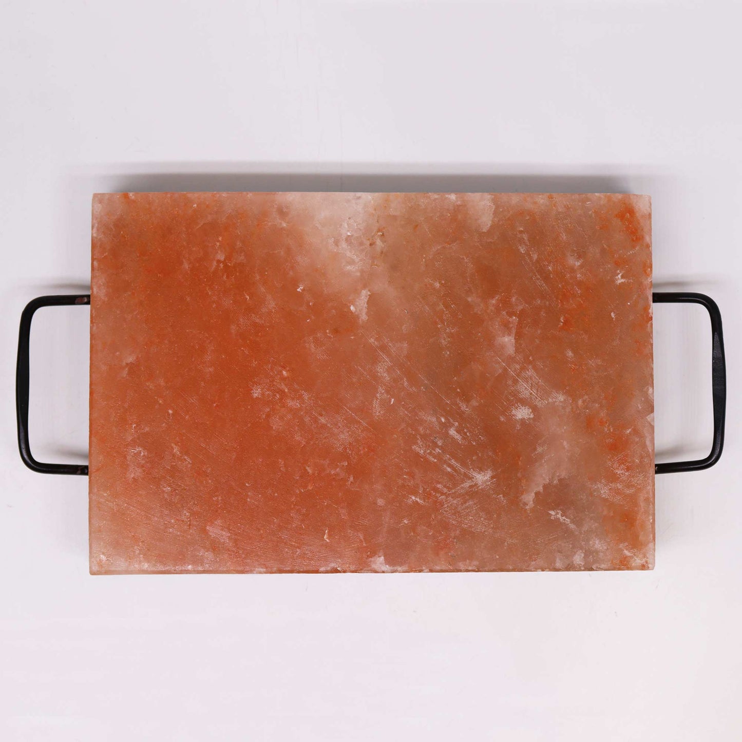 Top-down view of Himalayan salt BBQ plate on white surface