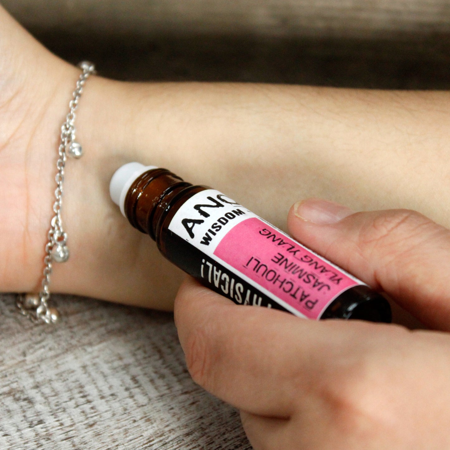 Wrist application of Energizing Citrus essential oil for alertness and natural energy.