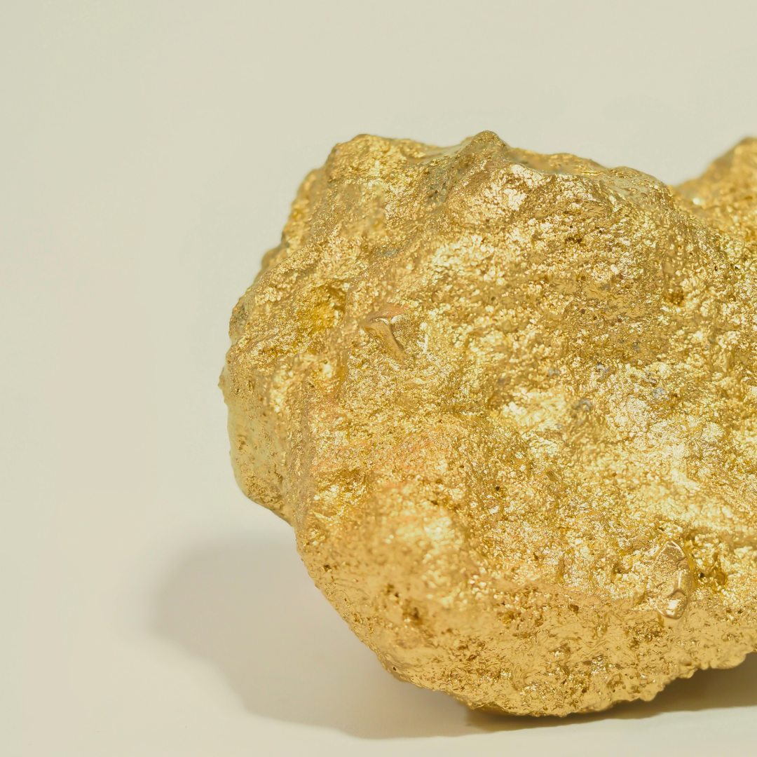 Close-up of a gold矿石 on a beige background