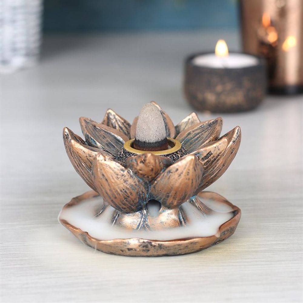 Bronze lotus incense burner placed on a wooden surface in a cozy home setting, styled for daily meditation and mindful living.
