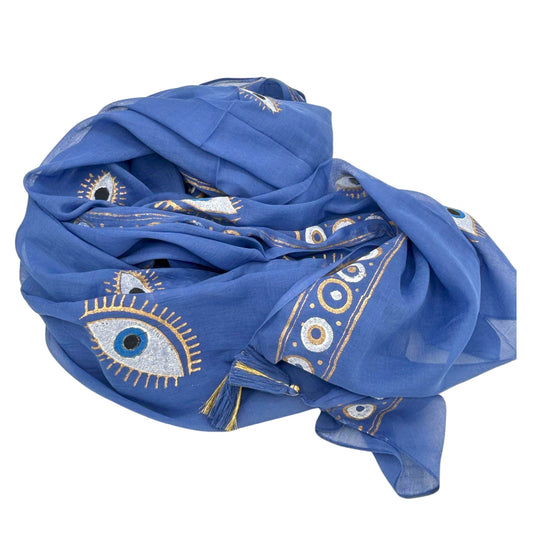 Rich blue cotton pario with hand-painted gold and white evil eye design, draped and folded with tassels