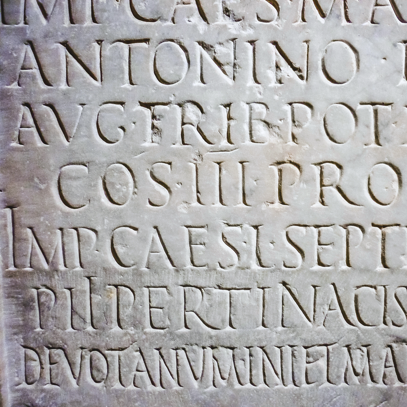 Carved stone inscription with Latin text on a stone surface