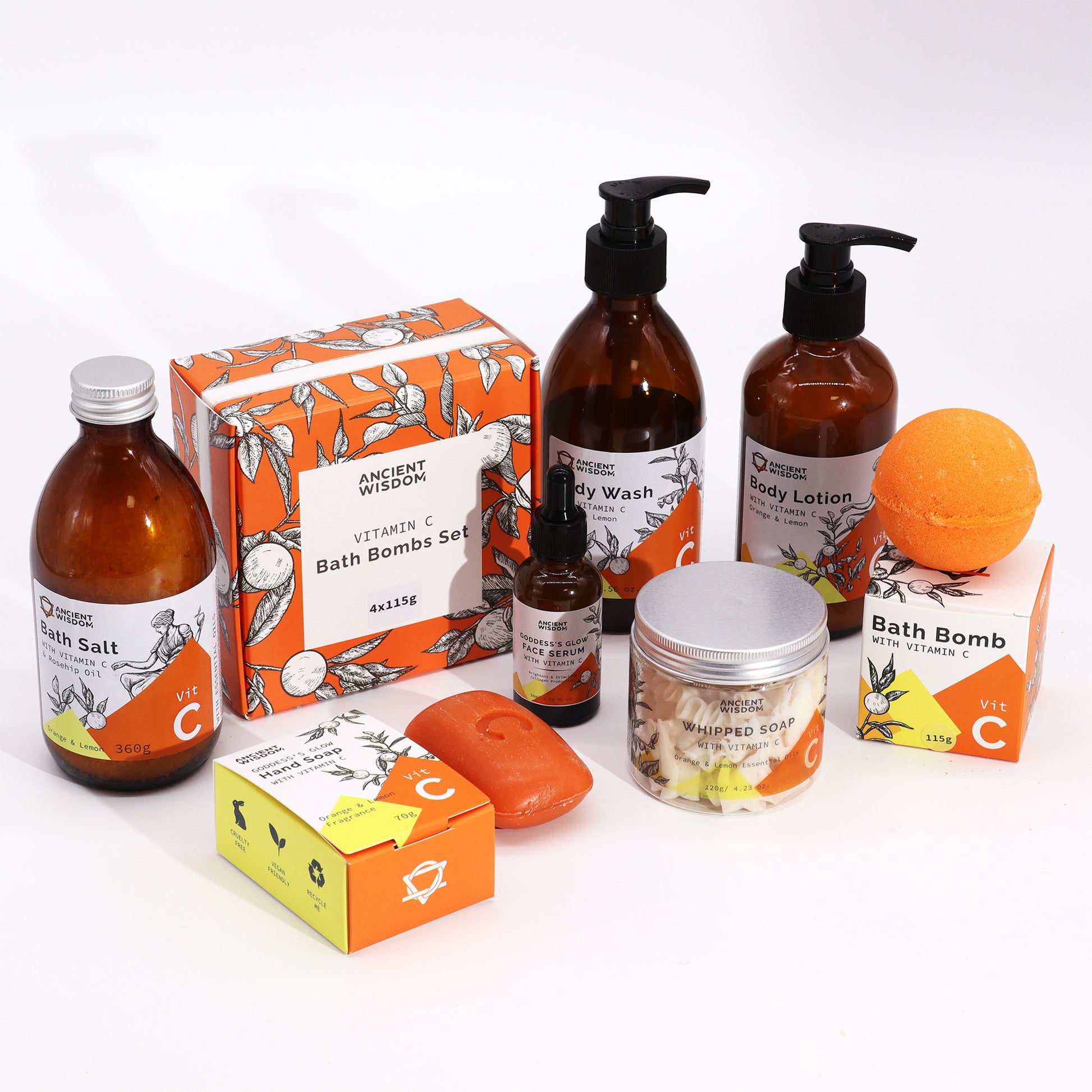 Flat lay of the full Sun Priestess Ritual collection, captured from above at a slight angle. Includes serums, lotion, cleanser, bath salts, and bath bombs arranged with citrus slices and gold-toned accents to evoke ancient beauty rituals.
