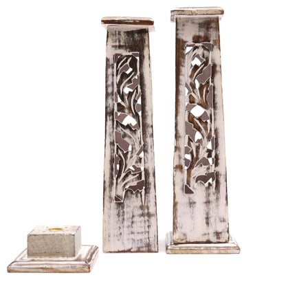 Side-by-side display of mango wood incense towers in dark and whitewashed finishes, both with carved lattice patterns.