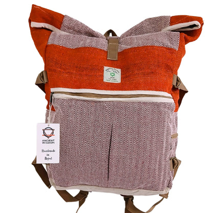 Front-facing view of Himalayan Sunset Orange hemp roll-top backpack with herringbone design