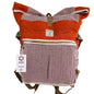 Front-facing view of Himalayan Sunset Orange hemp roll-top backpack with herringbone design