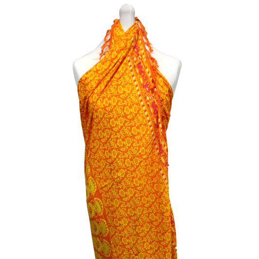 Lime and orange mandala sarong tied halter-style on mannequin, floral pattern and fringe visible