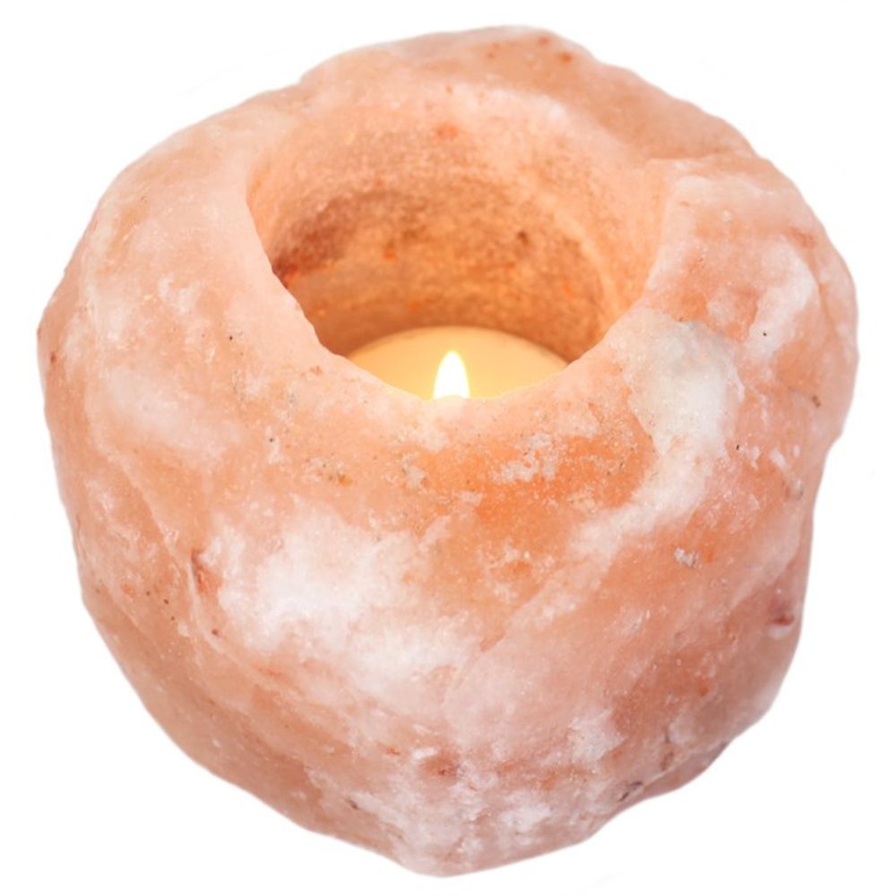 Glowing Himalayan salt candle holder with warm amber light, ideal for calming atmosphere and natural ionization.