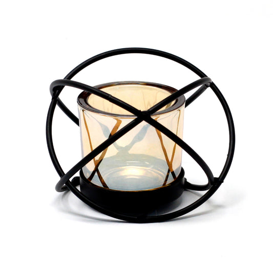 Angled view of sleek black iron votive candle holder with single glass cup, ideal for minimalist or industrial interior decor.