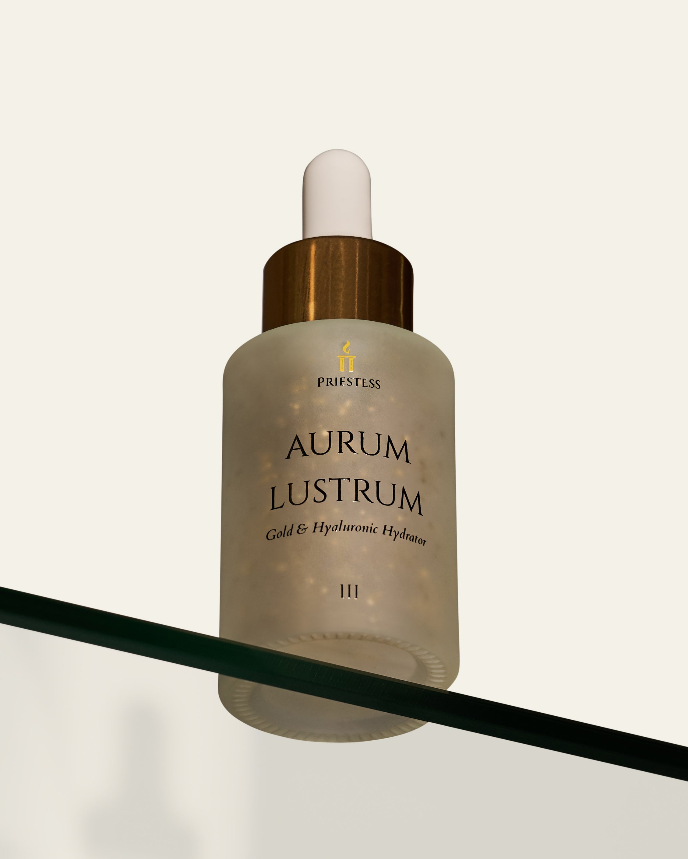 Skincare dropper bottle labeled 'Aurum Lustrum' on a reflective surface with a white background