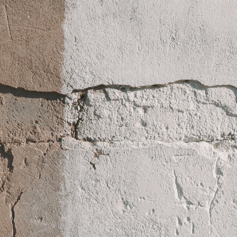 Close-up of a stone wall with a visible joint between two stones.