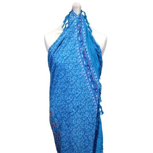 Sky blue rayon sarong with floral and elephant trim, tied halter-style on mannequin