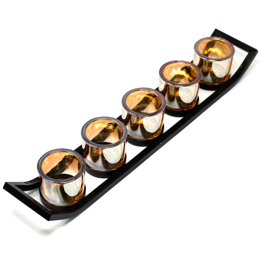 Angled view of sleek black iron votive candle holder with tiered ledge design, ideal for modern or industrial home decor.
