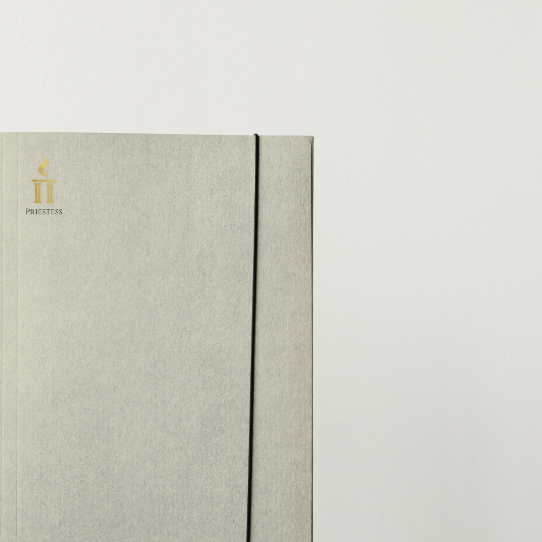 Close-up of a textured notebook with a visible brand logo on a light gray background