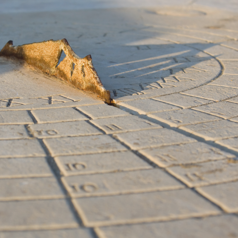 Close-up of a sundial on a stone surface
