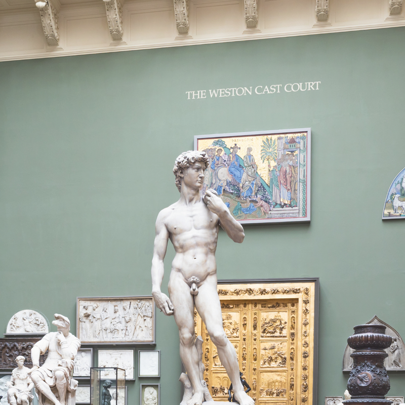Statue in a museum setting with 'The Weston Cast Court' on the wall.