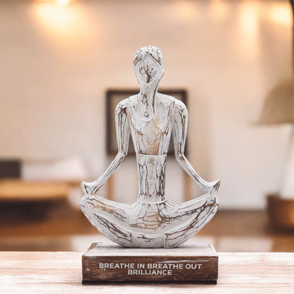 Wooden yoga sculpture displayed in a modern living room, adding a peaceful and spiritual touch to mindful home design.