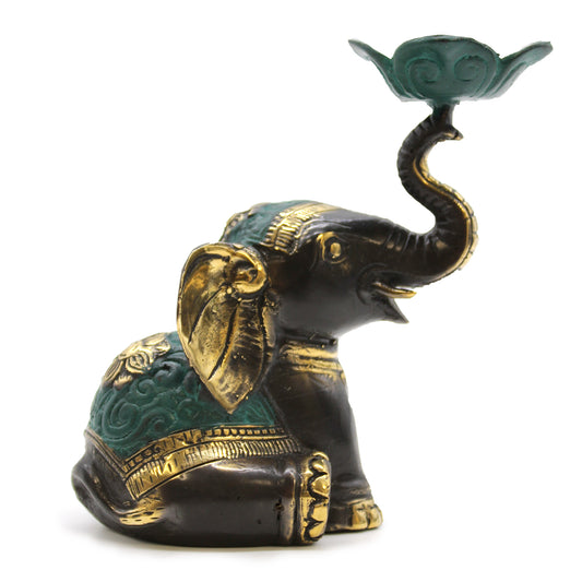Medium brass elephant candle holder with raised trunk and lotus platform, green and gold finish on white background