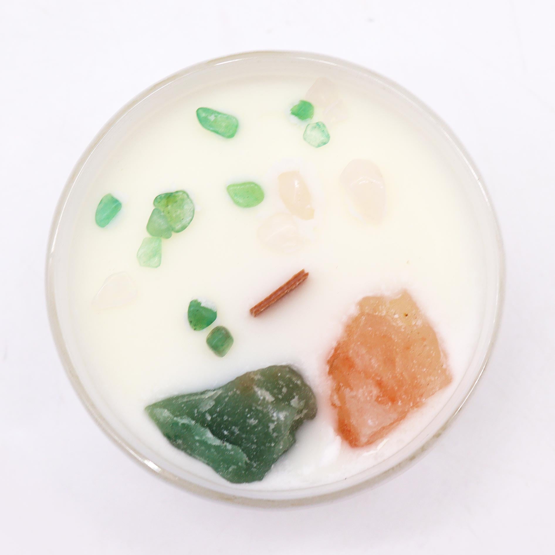 Top view of Heart Chakra Candle showing crystal-embedded soy wax and soft green coloring
