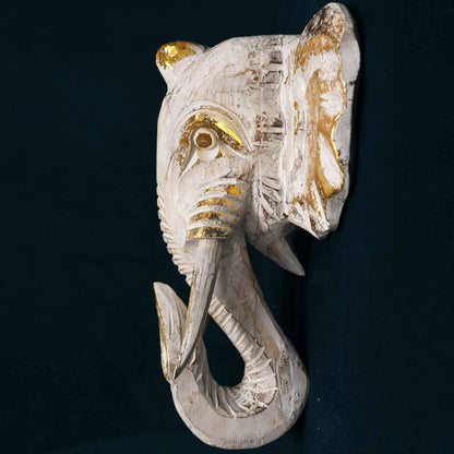 Side view of gold and whitewash elephant wall art showing carved detailing and depth