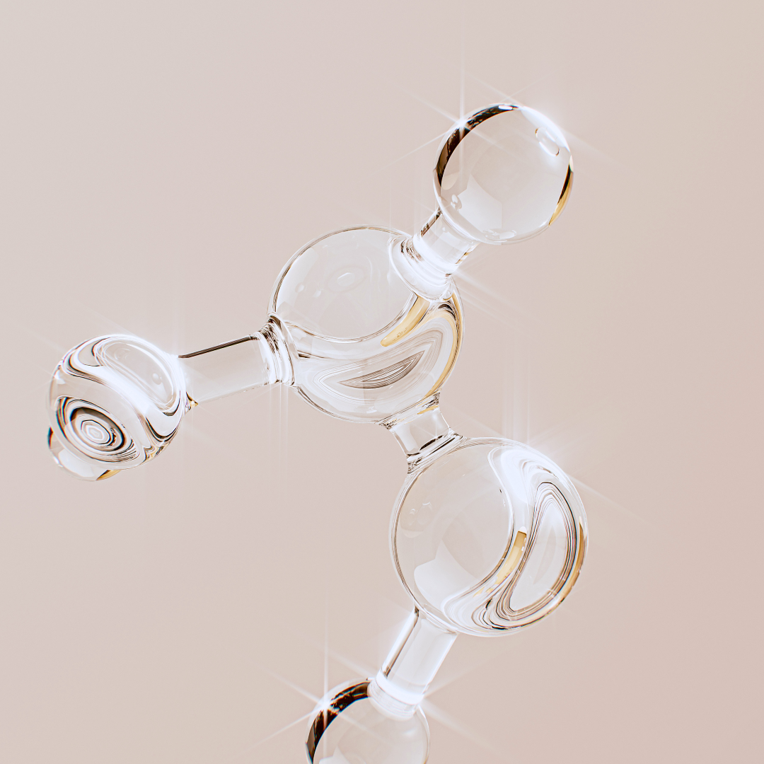 Clear glass molecular model on a beige background