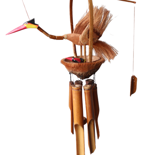 Handcrafted bamboo wind chime featuring mother bird and chicks, hanging on textured wall with coconut nest detail