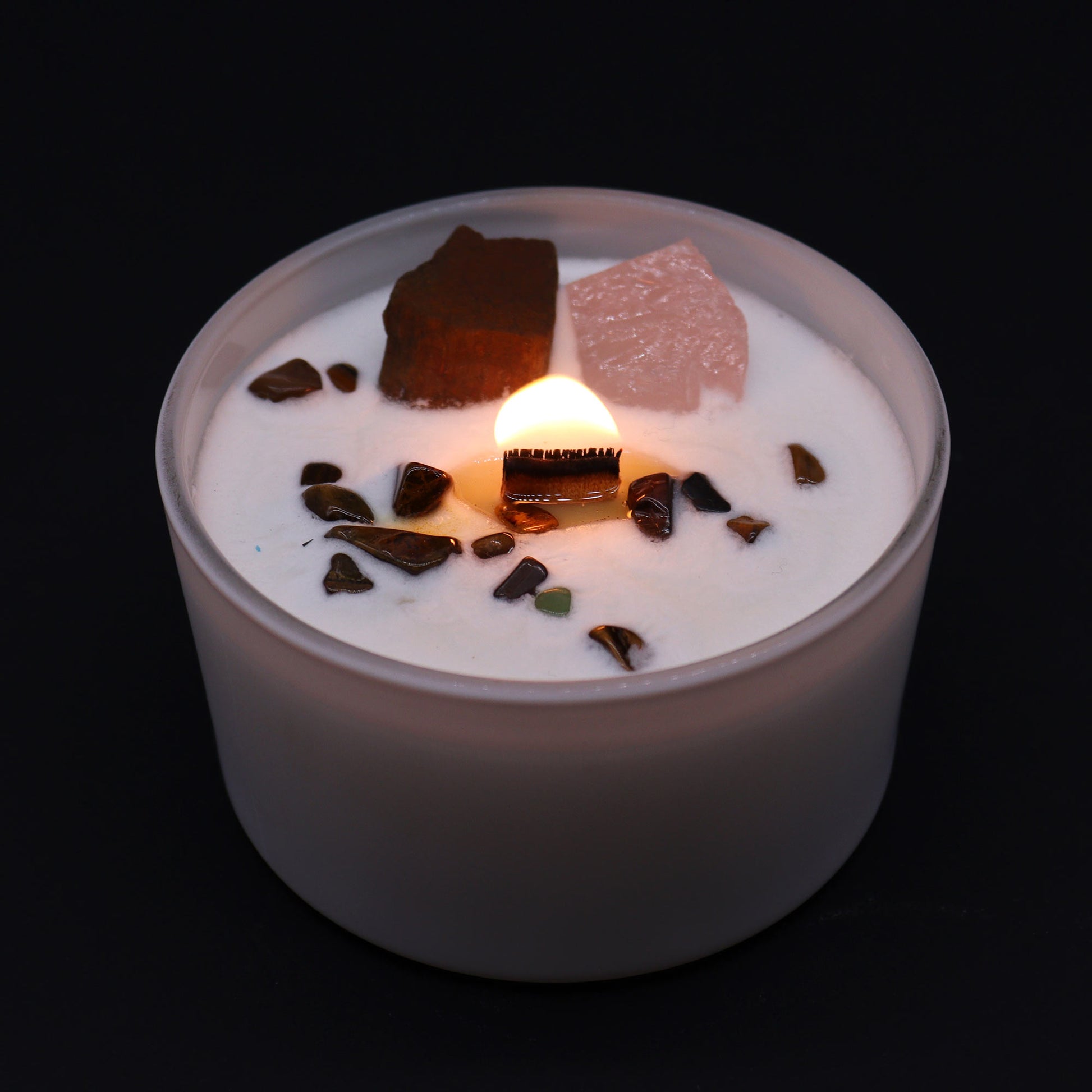 	Lit Sacral Chakra Candle with glowing flame and Invoking Dreams scent for creative ritual