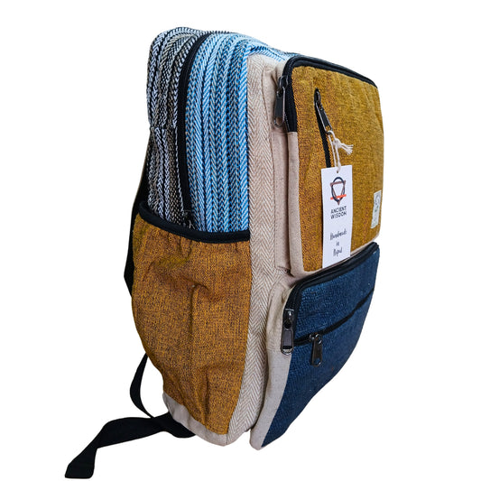 Large teal and turmeric hemp backpack in boxy shape with side zip pockets, handmade in Nepal from natural cotton and hemp blend