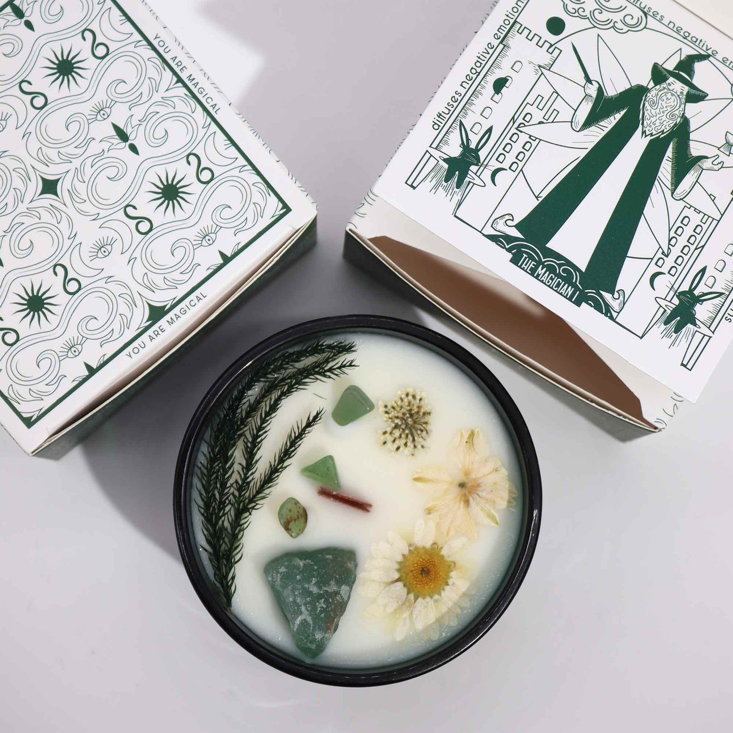 Packaging of The Magician Candle with tarot design, spearmint and vetiver notes, and energy of creation