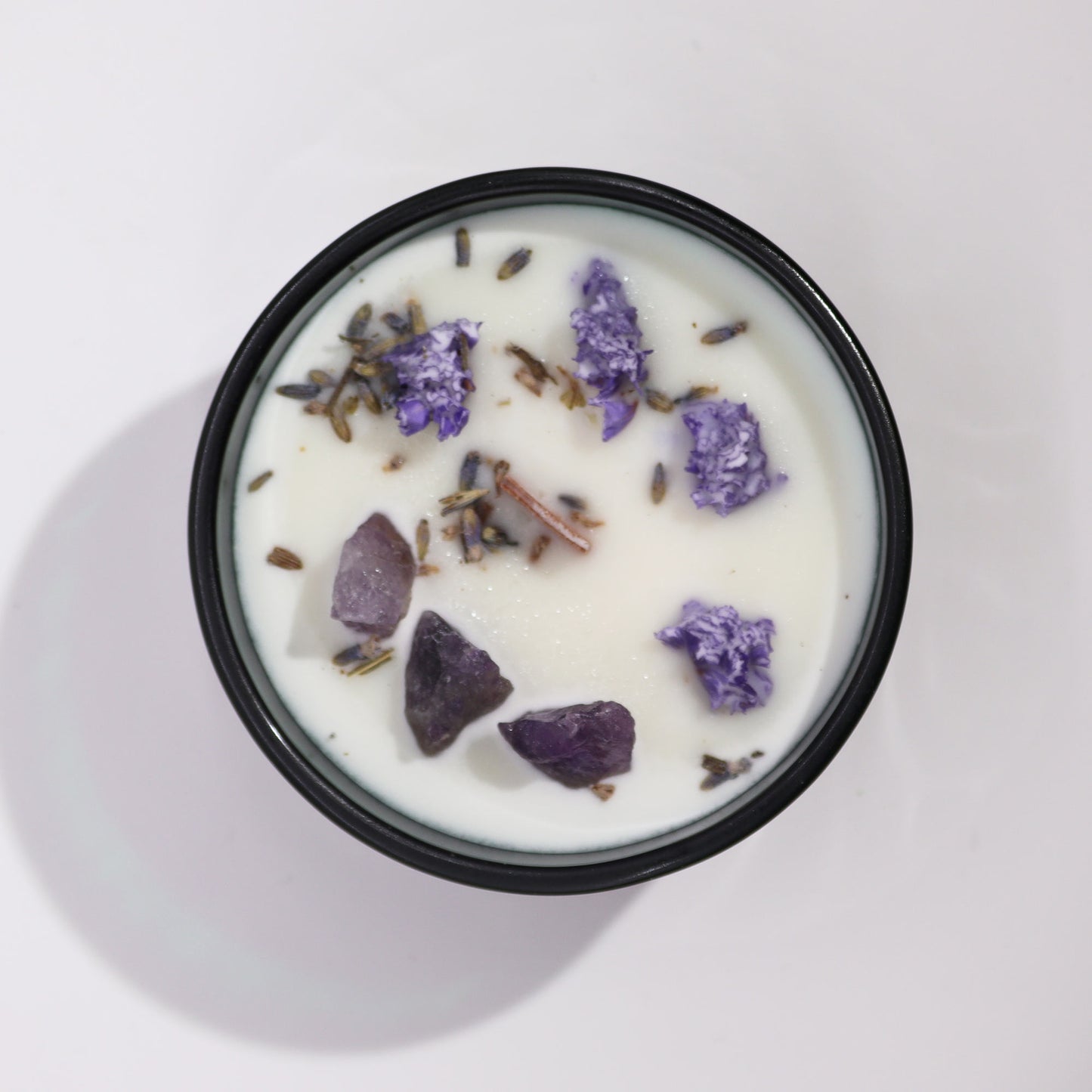 Top view of The Moon Candle showing soy wax, Amethyst crystals, and floral infusion for lunar rituals