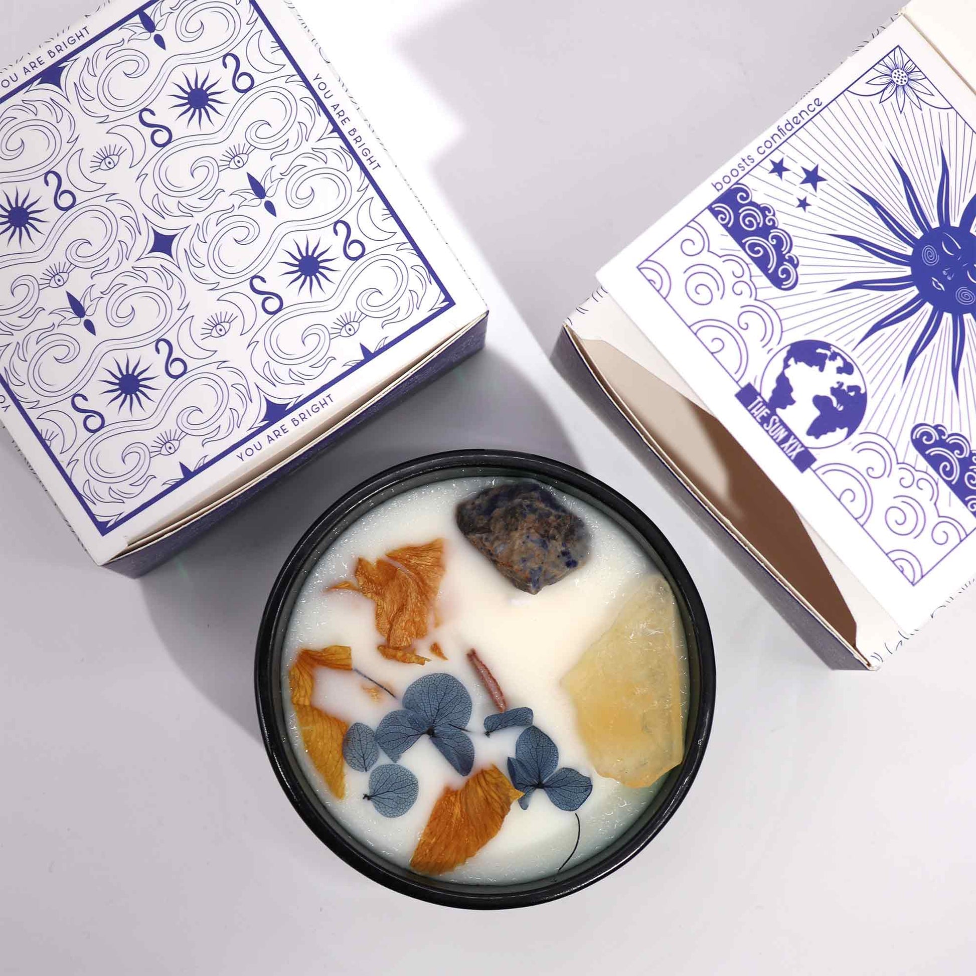 The Sun Candle styled in a sacred setting with crystals, citrus elements, and a solar-inspired altar aesthetic