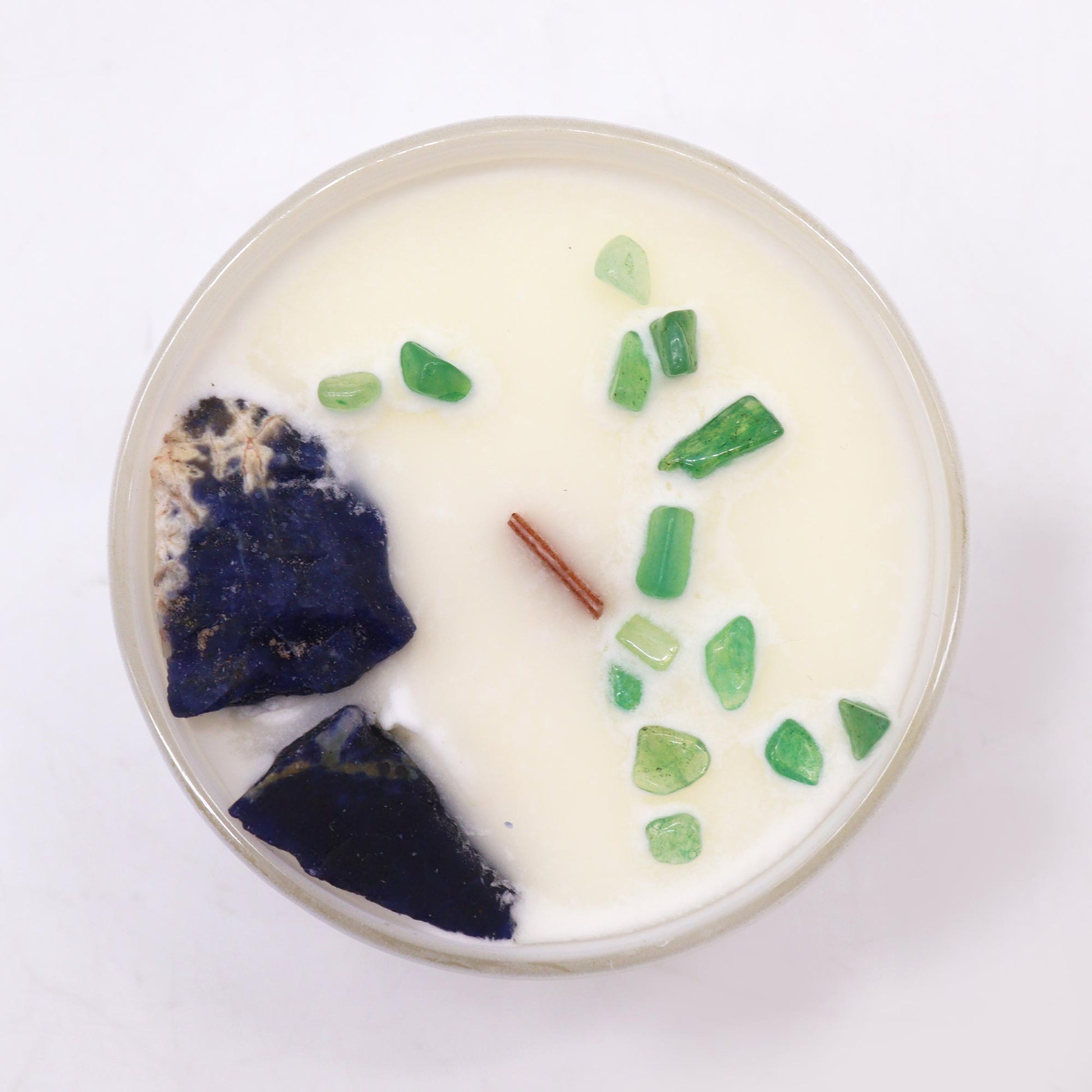 Top view of Throat Chakra Candle showing embedded crystals and blue soy wax for chakra healing